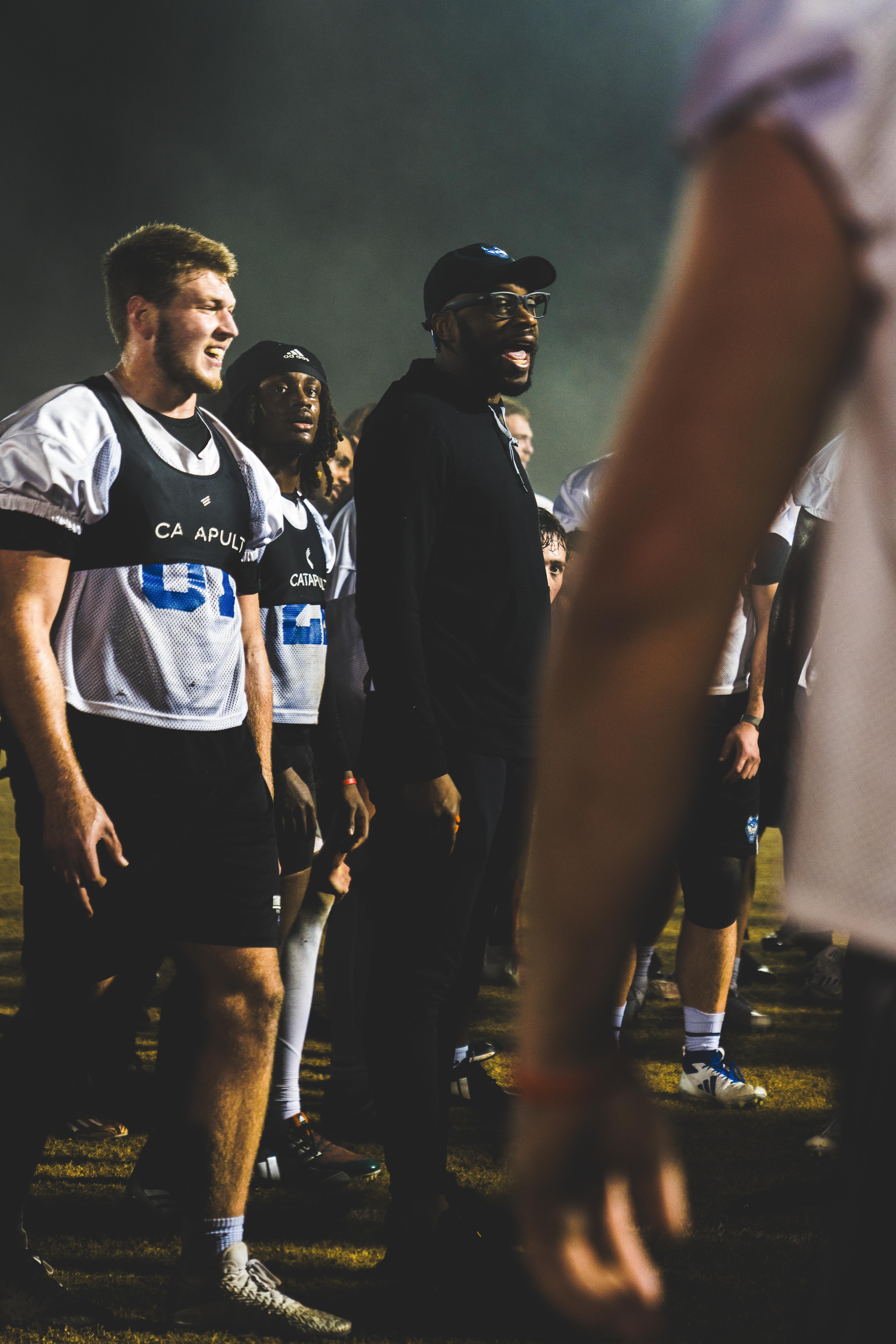 Players and coach yelling in middle